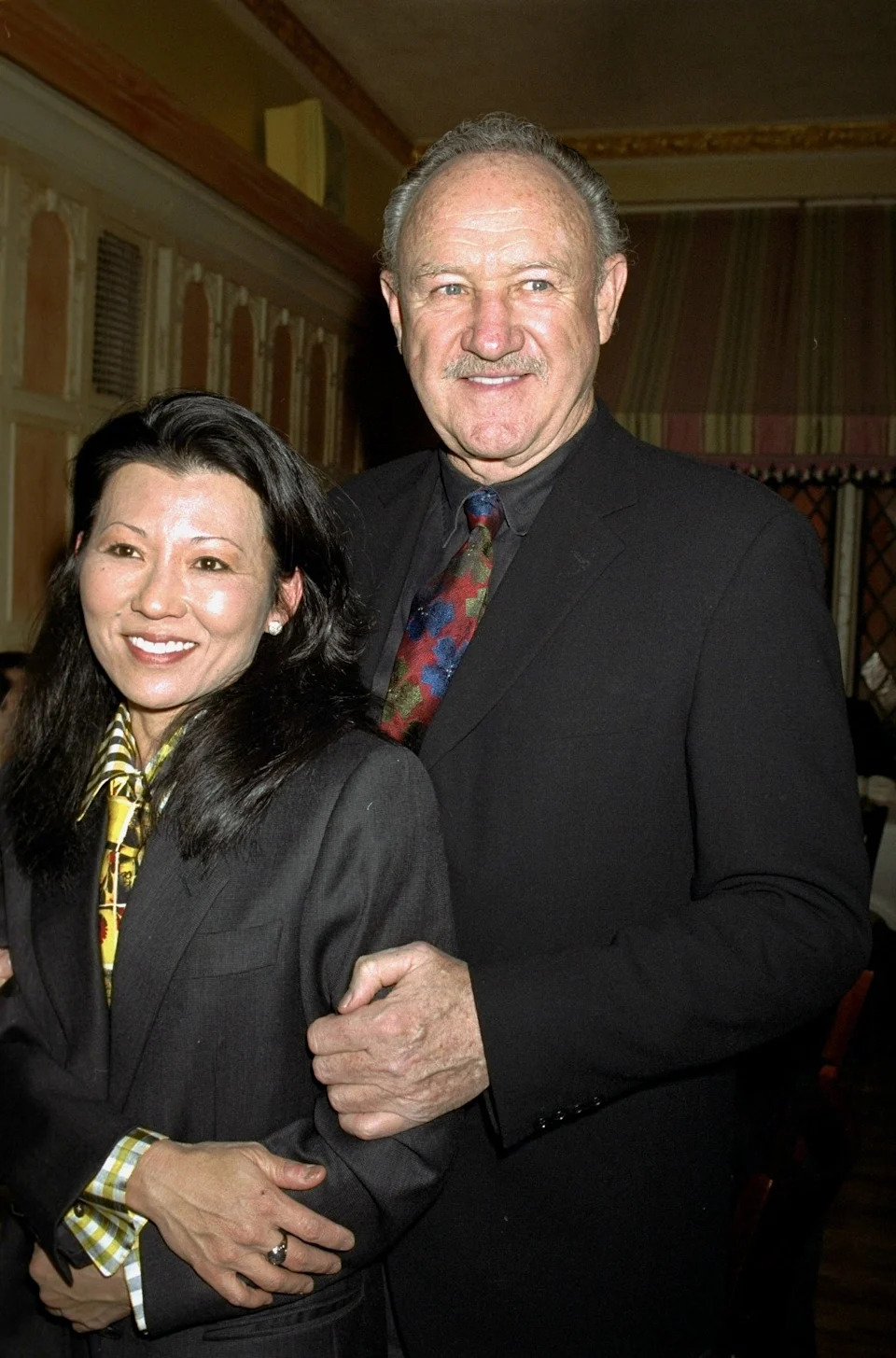 Gene Hackman and Betsy Arawaka smile in formal attire