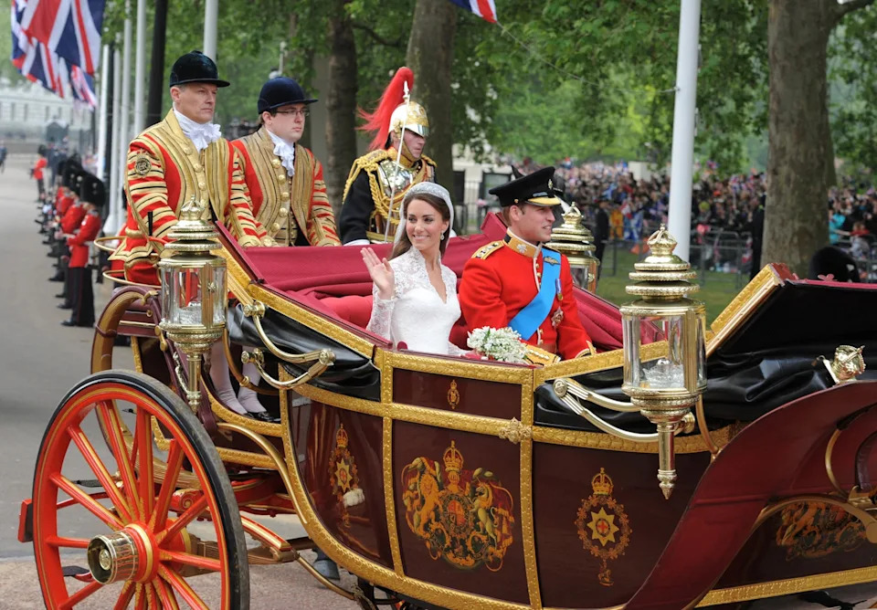 Dimitar Dilkoff/AFP via Getty Images - PHOTO: Britain's Prince William and wife Kate, Duchess of Cambridge wave as they travel in the 1902 State Landau carriage along the Processional Route to Buckingham Palace, in London on April 29, 2011.