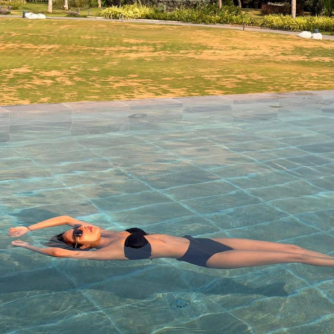 Priyanka Chopra lays in a pool wearing a black bikini, shared on Instagram