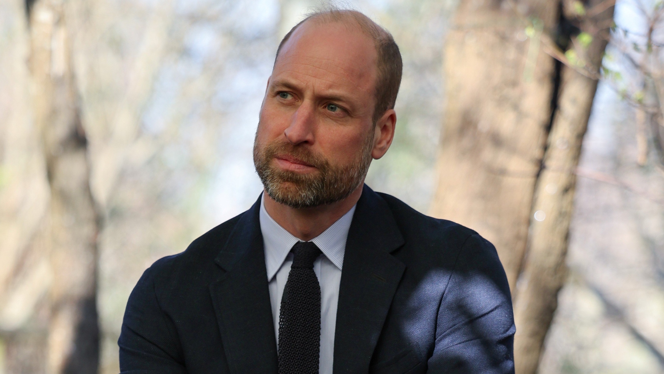 Prince William, Prince of Wales listens during a visit to the Bourne Academy