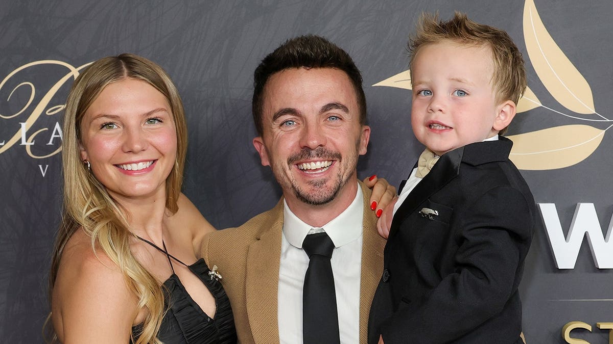Frankie Muniz standing with his wife Paige Muniz and son Mauz Muniz at an event