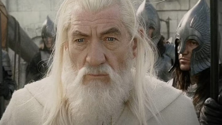 Gandalf (Ian McKellen) stands surrounded by armored soldiers in The Lord of the Rings: The Return of the King