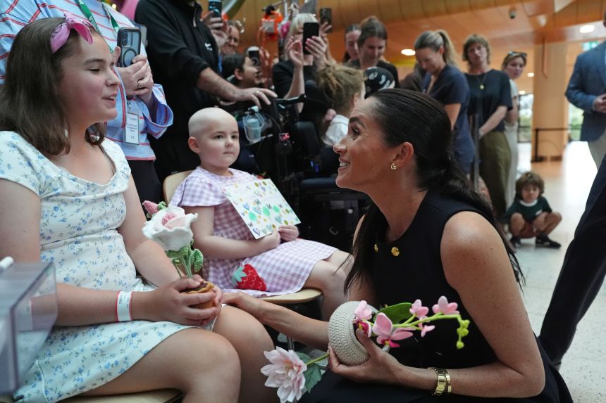 Meghan, Duchess of Sussex, receives flowers and a card from a young patient at the Royal Children's Hospital in Melbourne on April 14, 2026.