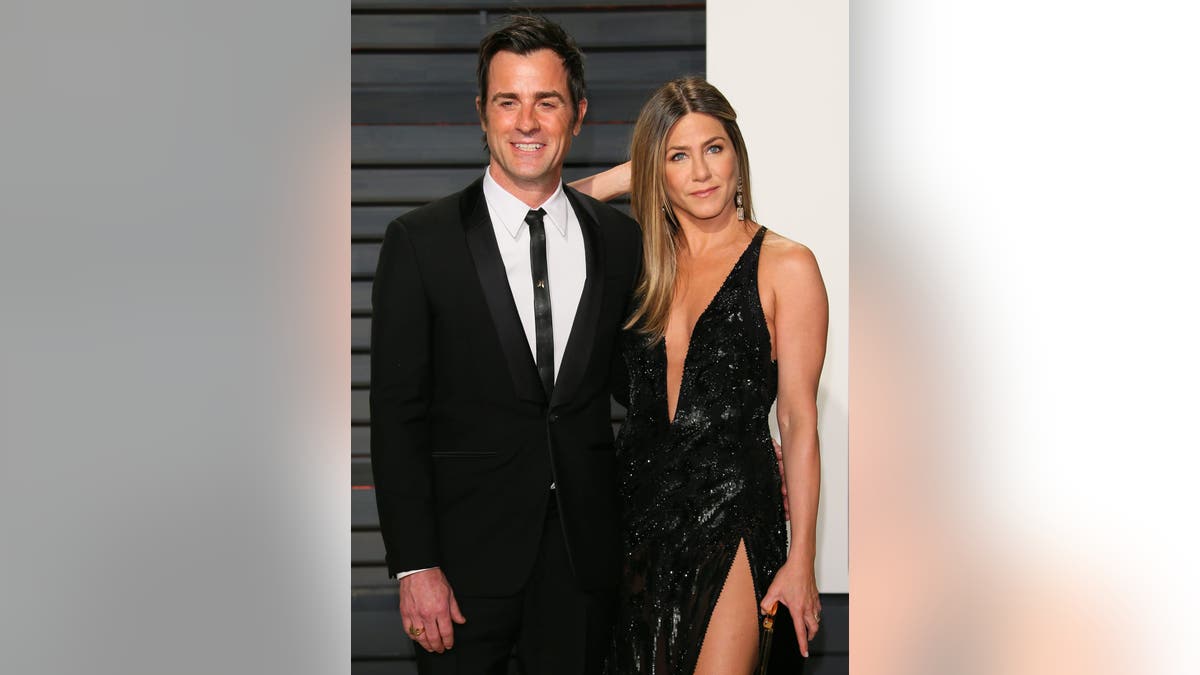 Jennifer Aniston and Justin Theroux standing together at the Vanity Fair Oscar Party in Beverly Hills