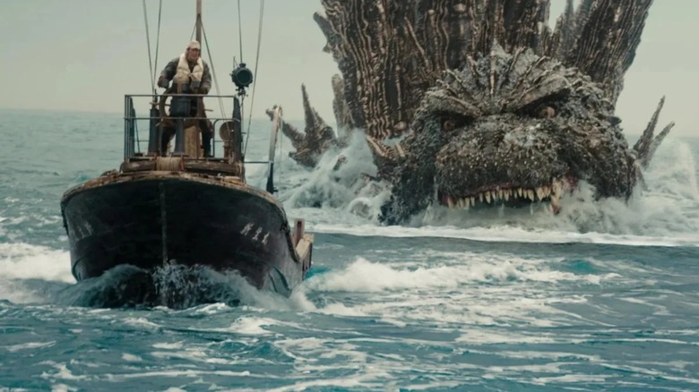 Godzilla pursues a small boat in the ocean in Godzilla Minus One