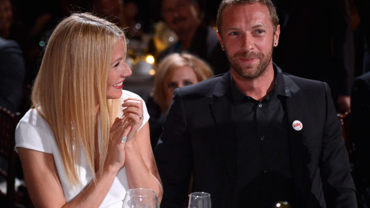 Gwyneth Paltrow and Chris Martin standing together at a gala event in Beverly Hills