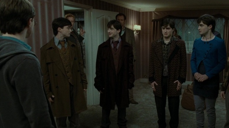 Several Harrys (Daniel Radcliffe) standing in a room together in Harry Potter and the Deathly Hallows - Part One