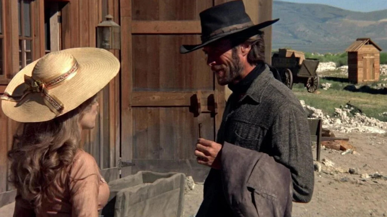 The Stranger (Clint Eastwood) standing across from Callie (Mariana Hill) in 