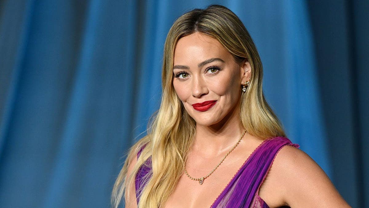 Hilary Duff standing and smiling at the Academy Museum Gala in Los Angeles