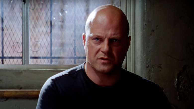 Mackey sitting in a dark room on 