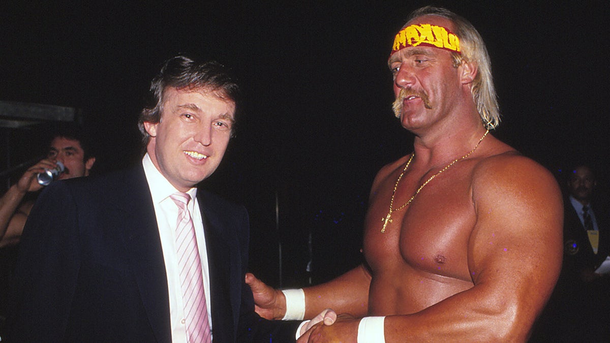 Businessman Donald Trump and wrestler Hulk Hogan standing together at Wrestlemania VI Convention Hall in Atlantic City