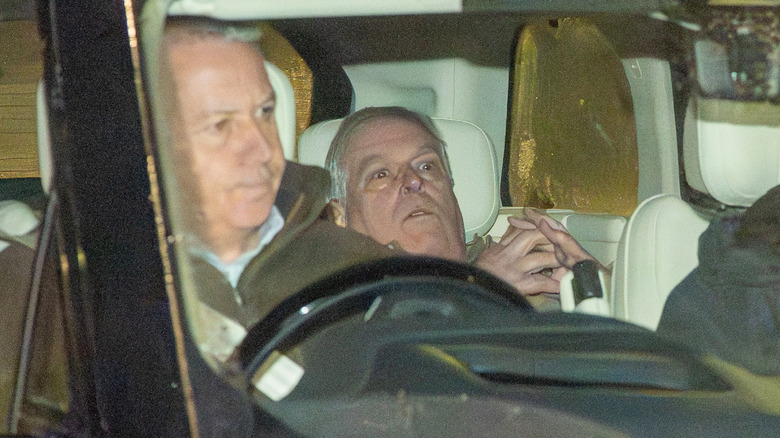 Andrew Mountbatten-Windsor leaning back in the back seat of a car