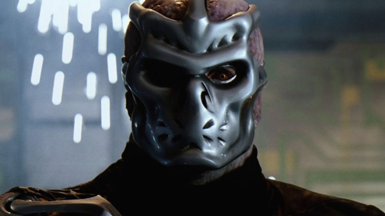 Kane Hodder  wearing his cyborg Jason mask in front of sparks in Jason X