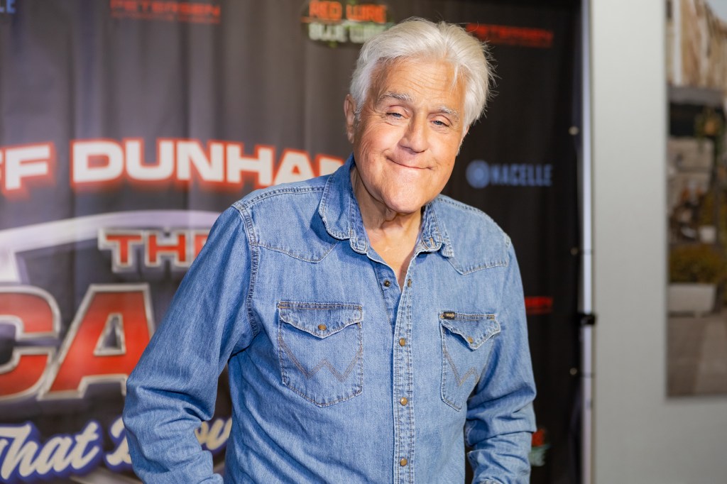 Jay Leno smiles, wearing a denim shirt, at the release party for "The Cars That Drove Us."