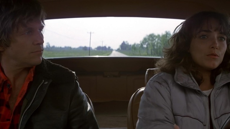 Jeff Bridges as Starman and Karen Allen as Jenny Hayden sitting in a car together in Starman (1984)