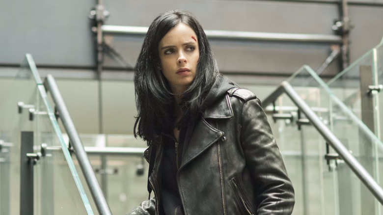 Krysten Ritter as Jessica Jones sports a cut on her head as she walks down stairs in Jessica Jones