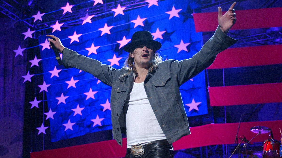 Kid Rock performing in front of an American flag at Ramstein Air Base in Germany