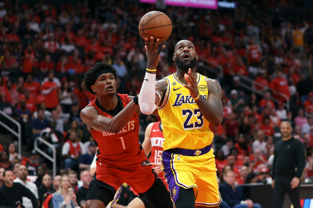 LeBron James of the Los Angeles Lakers attempts a shot over Amen Thompson of the Houston Rockets during an NBA playoff game.
