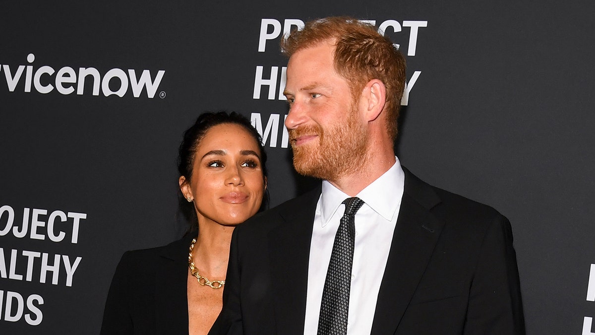 Meghan, Duchess of Sussex, and Prince Harry, Duke of Sussex, standing together at an event.