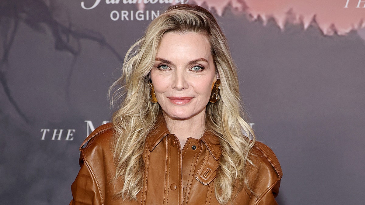 Michelle Pfeiffer posing on the red carpet at The Madison premiere in New York City