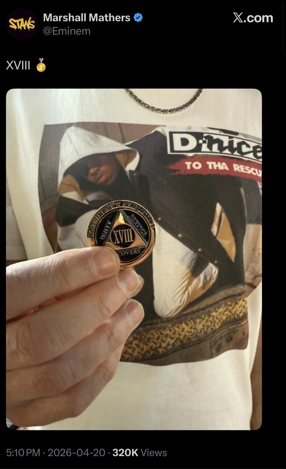 Eminem hits 18 years of sobriety, sharing his milestone chip marked “XVIII.”