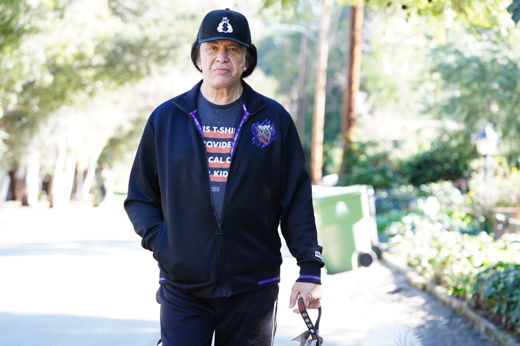 Gene Simmons walking his dog outside.