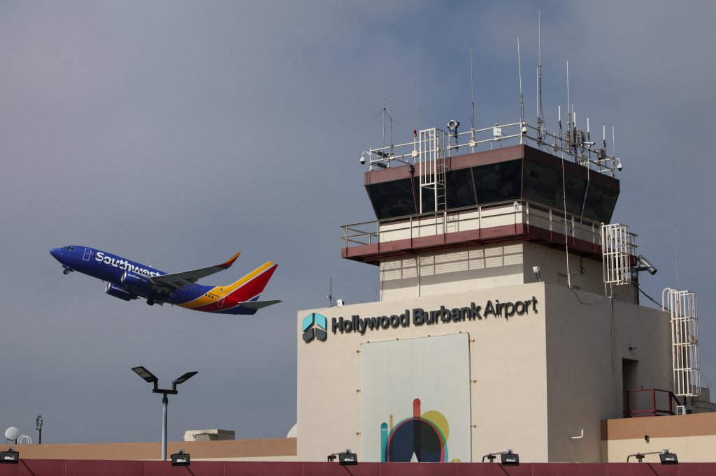 A Southwest Airlines plane takes off from Hollywood Burbank Airport, with the control tower in the background, a day after operations resumed following a staffing shortage.