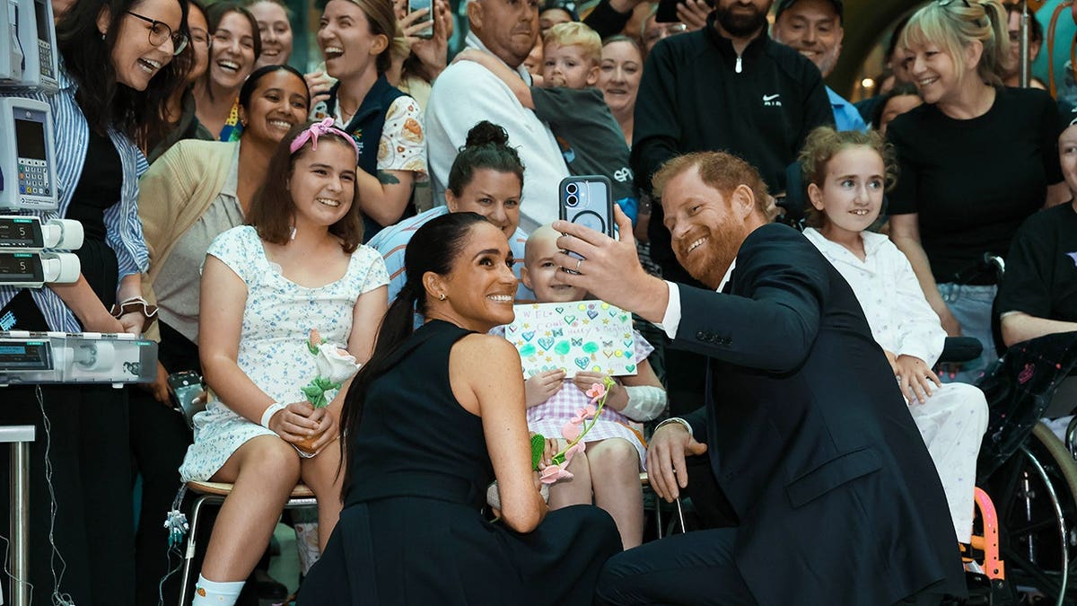 Prince Harry and Meghan Markle standing inside The Royal Children's Hospital in Melbourne