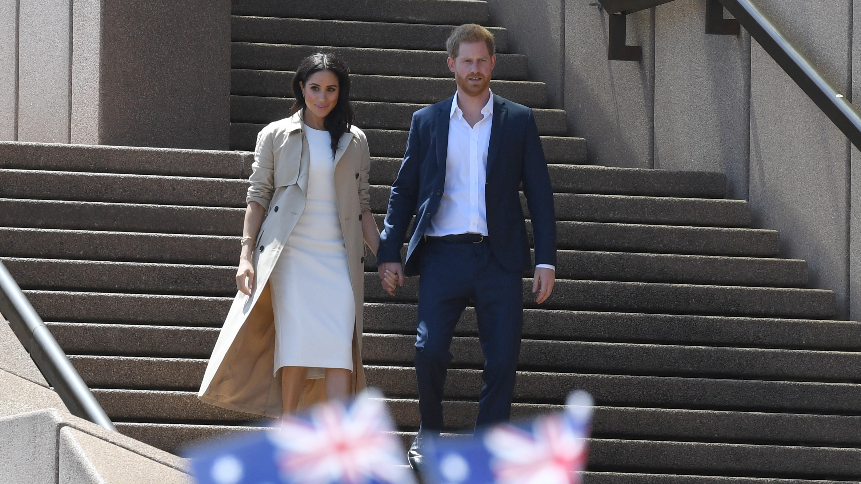 Meghan Markle and Prince Harry walk down steps at the Sydney Opera House on Oct 19, 2018