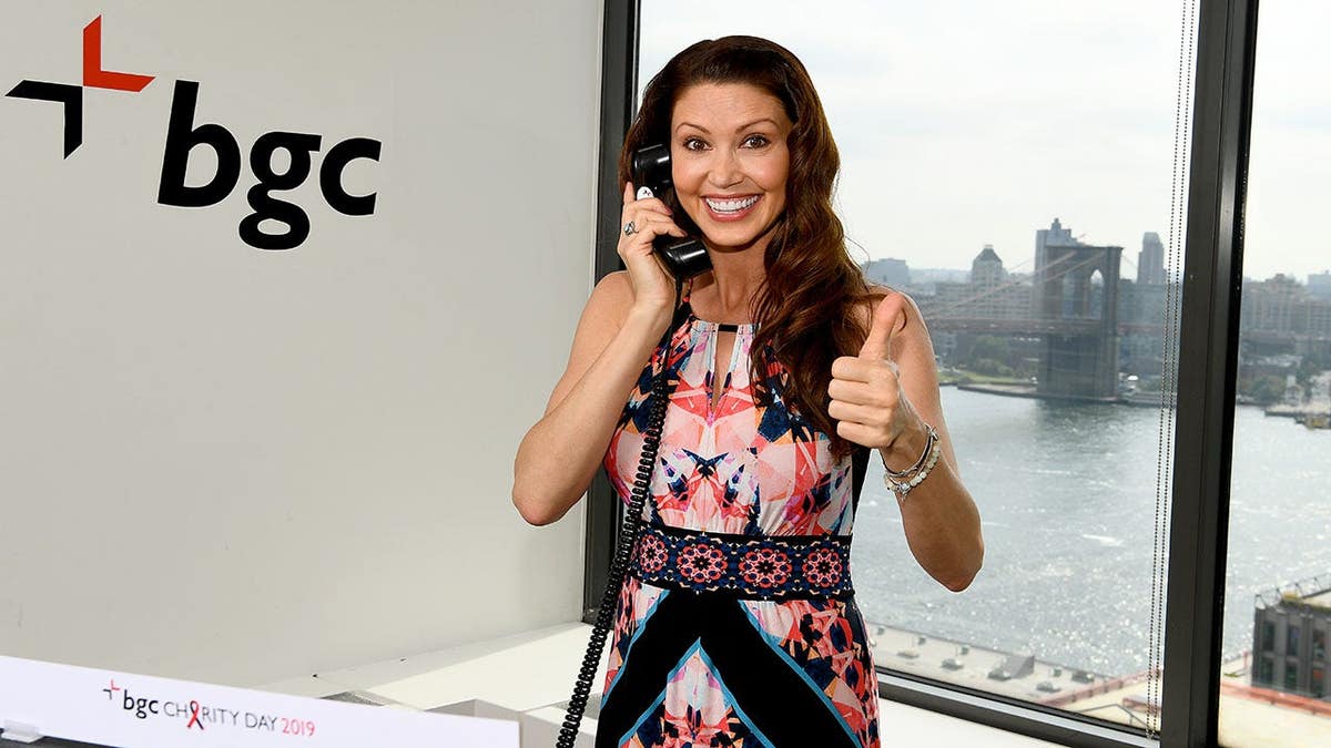 Shannon Elizabeth standing inside BGC office at Annual Charity Day event