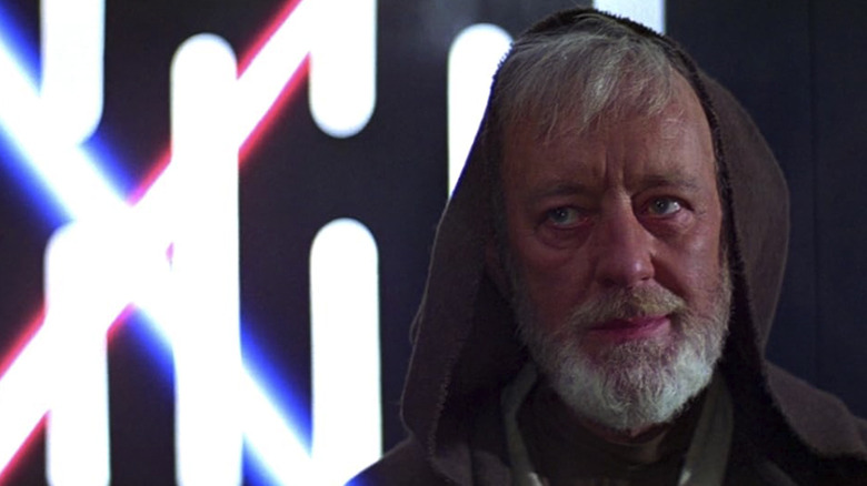 Alec Guinness as Obi-Wan, ready for a lightsaber fight in Star Wars
