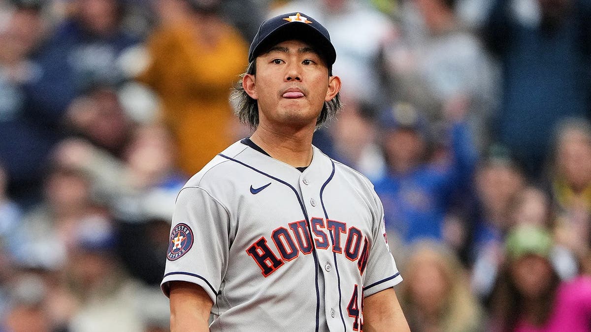 Houston Astros pitcher Tatsuya Imai reacting after allowing a run on a wild pitch.