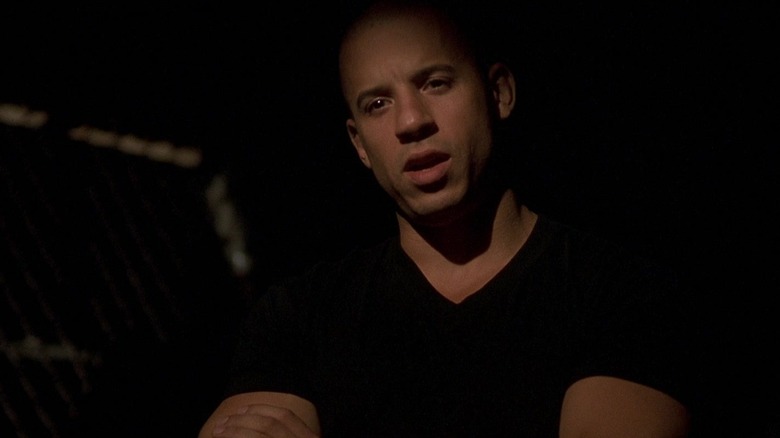 Dom, arms crossed at night, in The Fast and the Furious