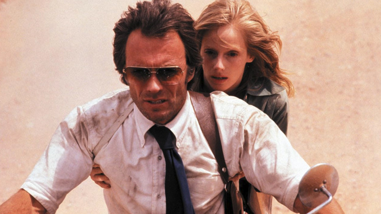 Ben Shockley drives a motorcycle with Guy Mally grabbing on behind him