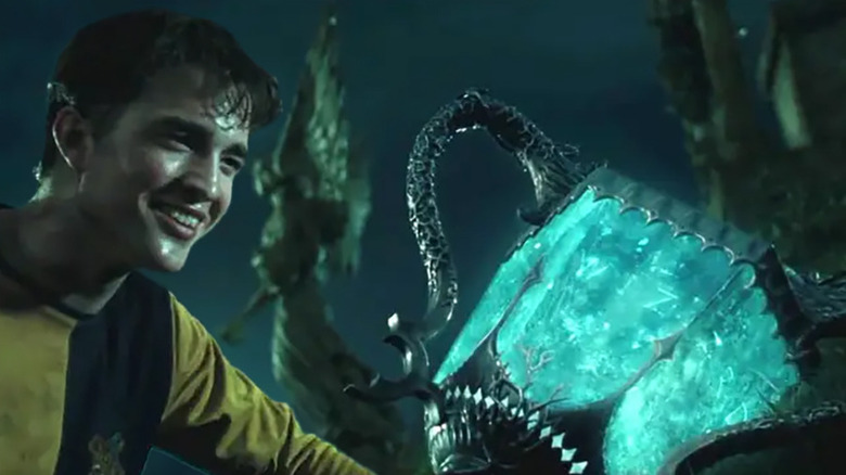 Cedric Diggory (Robert Pattinson) next to a portkey in Harry Potter and the Goblet of Fire