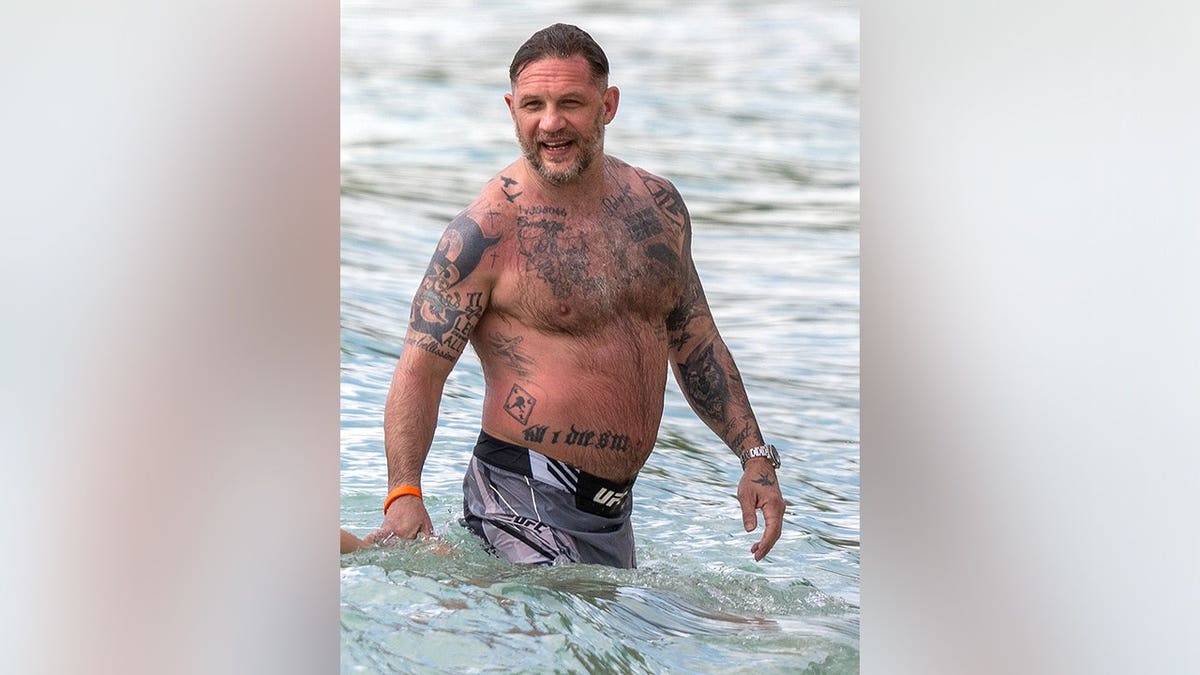 Tom Hardy in a UFC swimsuit while on vacation in Barbados in April 2026.
