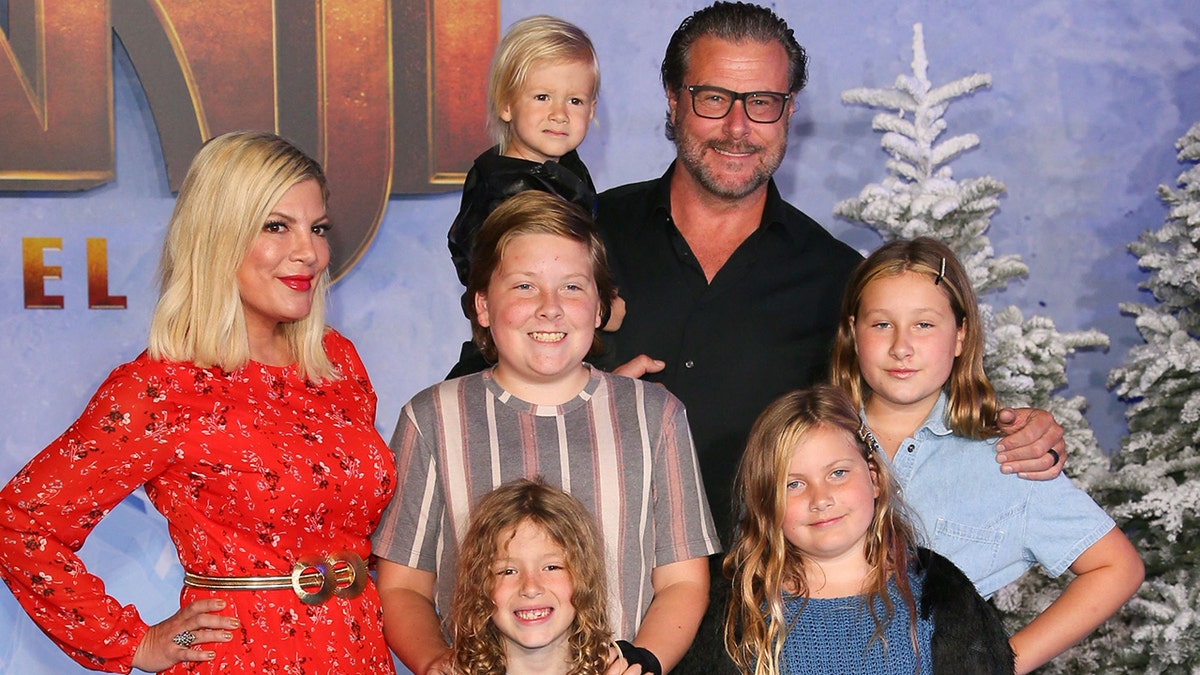 Actress Tori Spelling and husband actor Dean McDermott arrive with children at TCL Chinese Theatre.