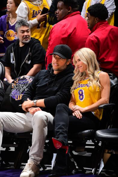 Matthew Stafford and Kelly Stafford pose for a photo at an NBA game.