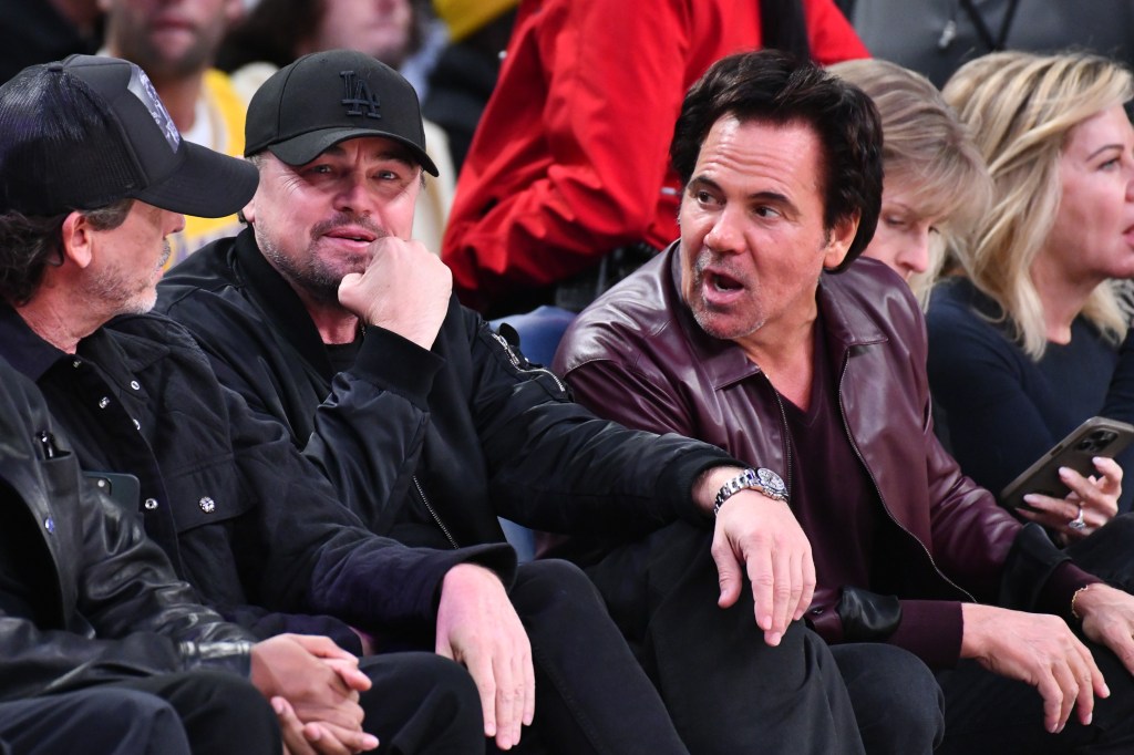 Leonardo DiCaprio and Tom Gores at a basketball game.