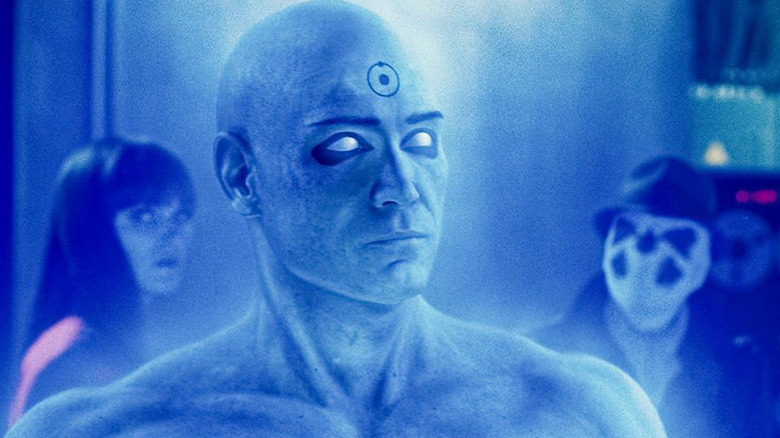 Doctor Manhattan glows the room blue while Silk Spectre and Rorschach look on in Watchmen (2009)