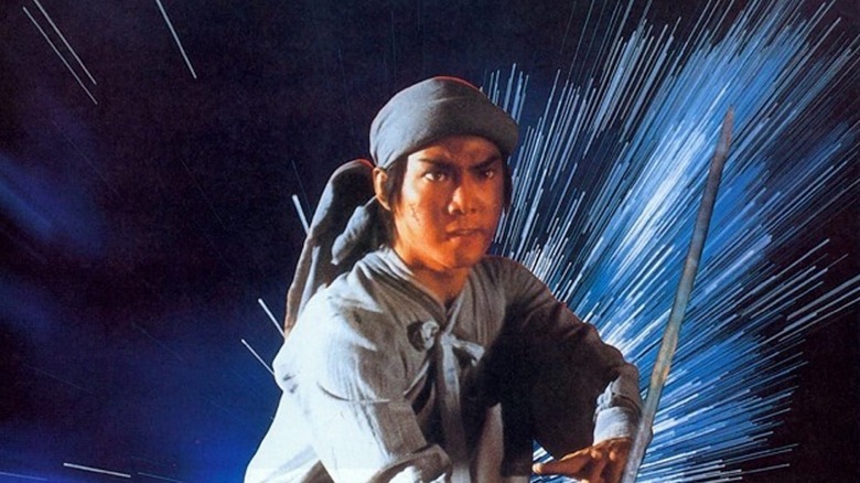 Yuen Biao as Dik Ming-kei brandishes a sword as stars stream behind him in Zu: Warriors from the Magic Mountain