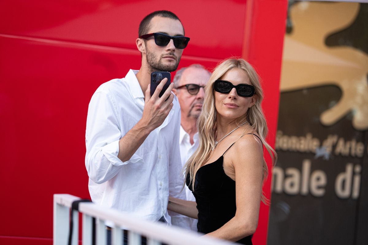 Sienna Miller and her partner Oli Green at Venice Film Festival in 2024.