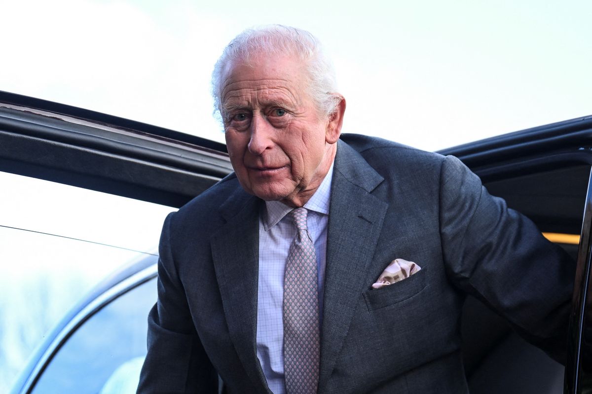 King Charles III steps out of a car during a visit