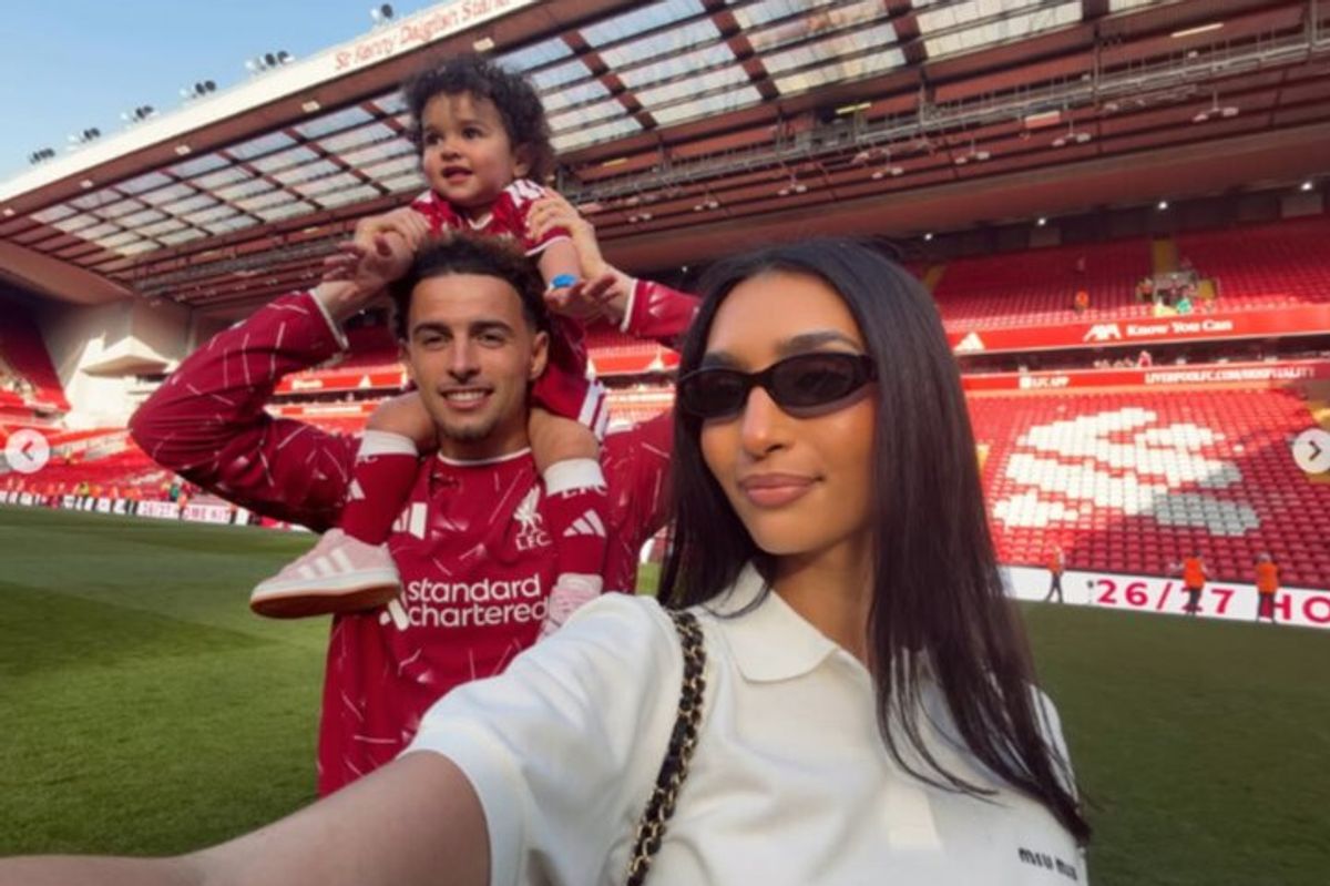 Saffie and Curtis on the pitch at Anfield with Giselle