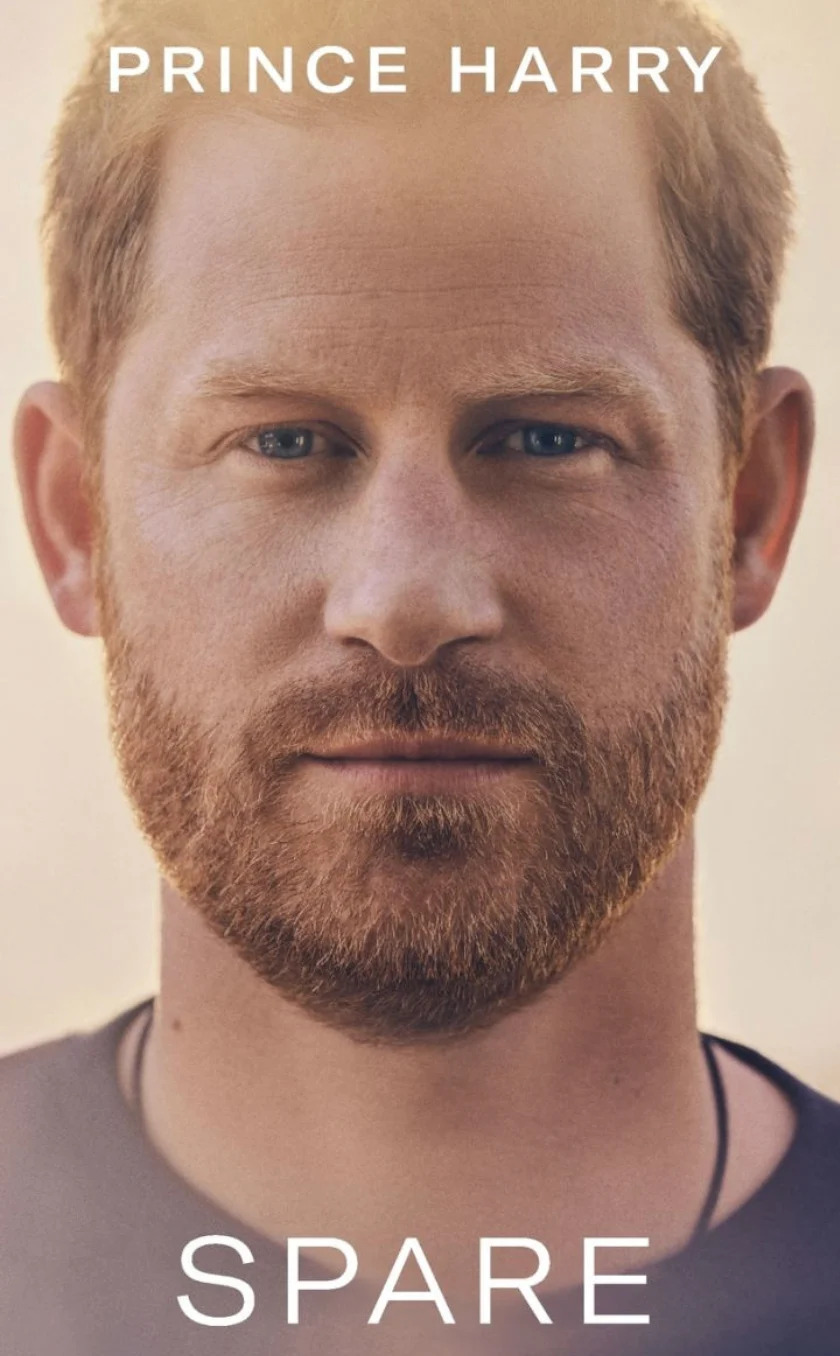 Close-up of a book cover featuring a man with short hair and a beard. Title: "Spare" by Prince Harry