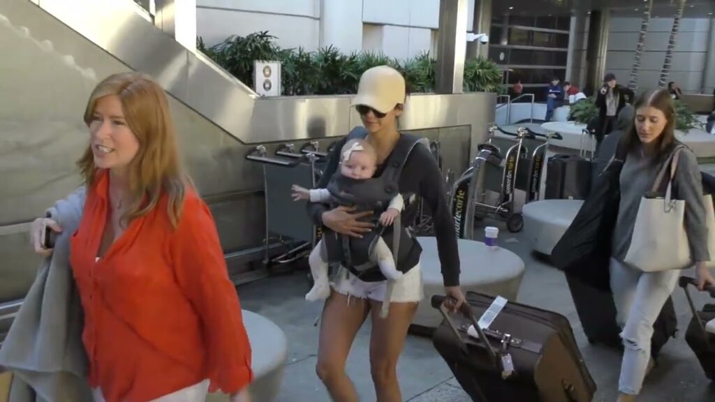 Nina Dobrev holding baby arriving at LAX Airport in Los Angeles
