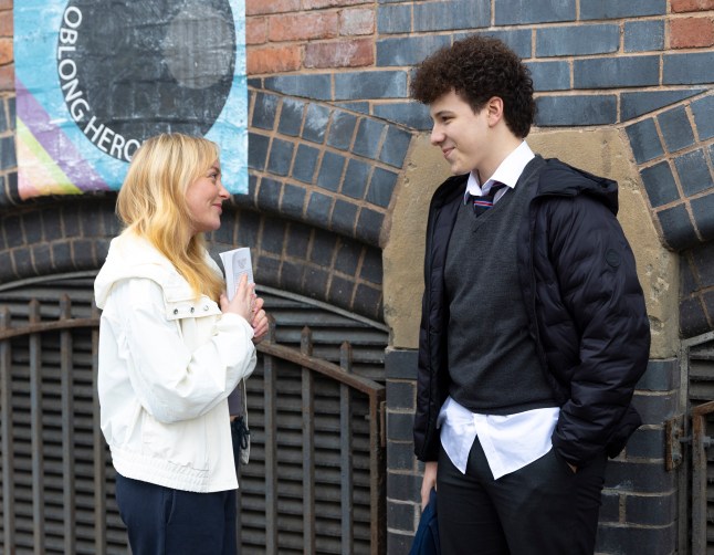 Megan and Will smiling at each other in Corrie