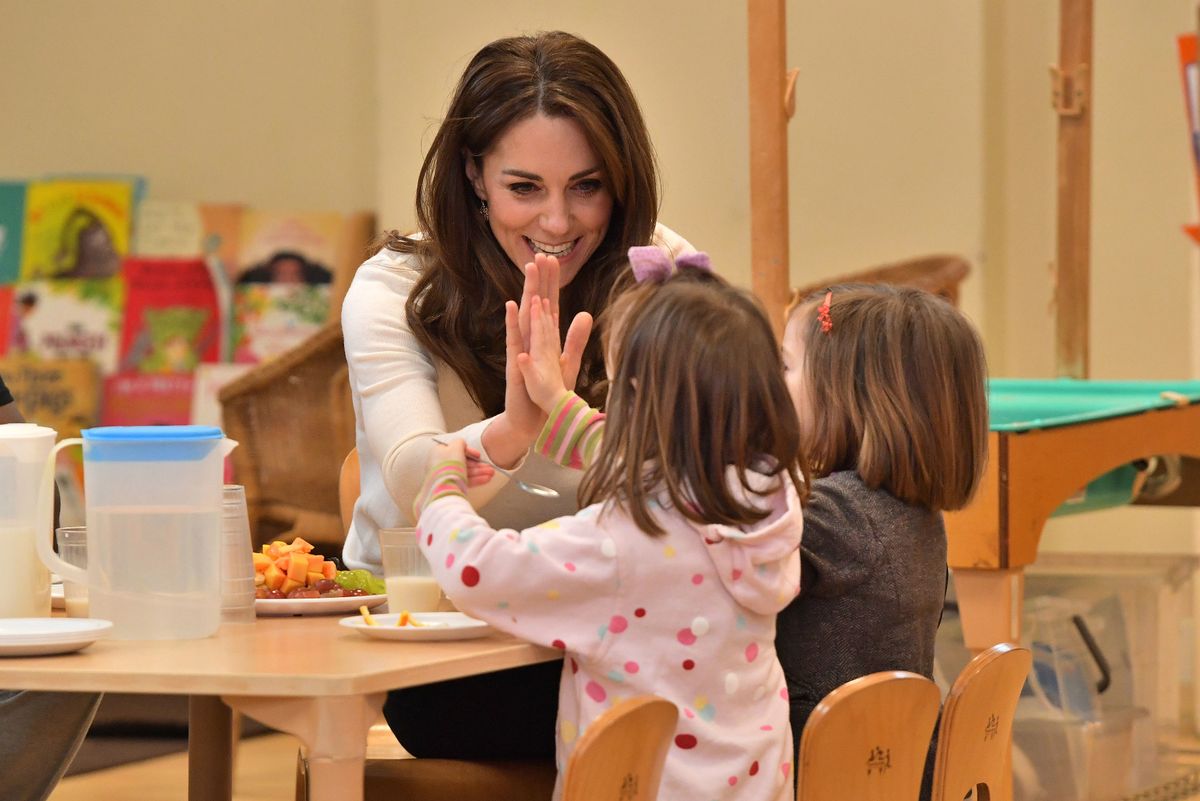 The Princess of Wales does a high five with two children during a visit to London Early Years Foundation Stockwell Gardens Nursery and Pre-school, in south west London, on January 29, 2020
