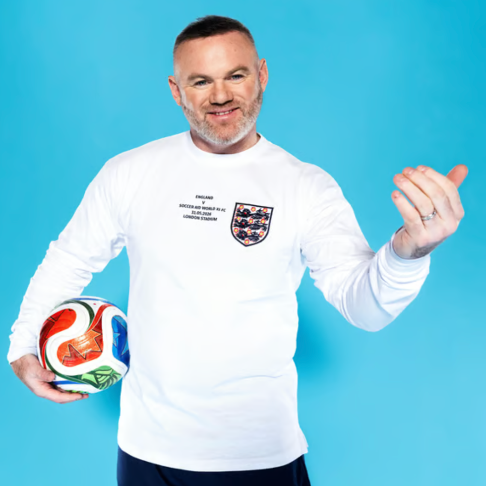 Soccer aid line up man in a longsleeve shirt holding a soccer ball against a blue background