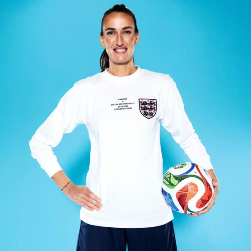 Soccer aid line up person holding a soccer ball wearing a longsleeved shirt